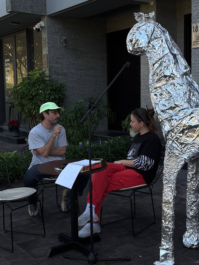 Conversation beside the silver creature